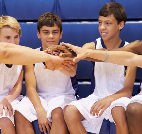 Youth athletes participating in a huddle