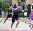 Female basketball players playing outside