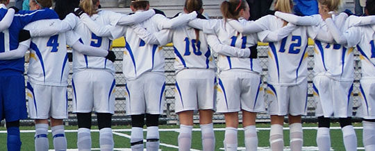 Female soccer team standing together
