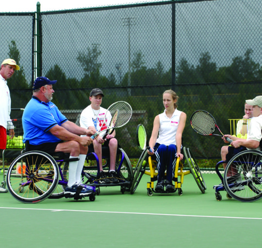 Wheelchair tennis players on a court