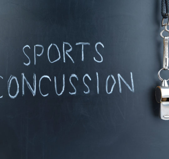A black board with "Sports Concussion" written on it
