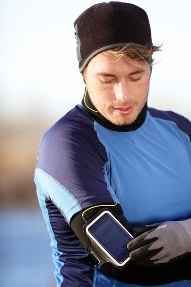 Close up of runner with arm strap music console.