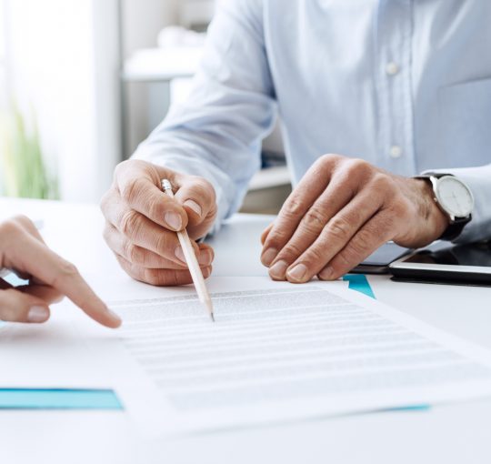 Two people reading a document