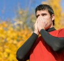 A runner blowing their nose