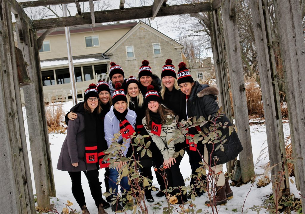 9 People posing for a picture outside in the winter