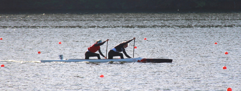Two rowers on lake