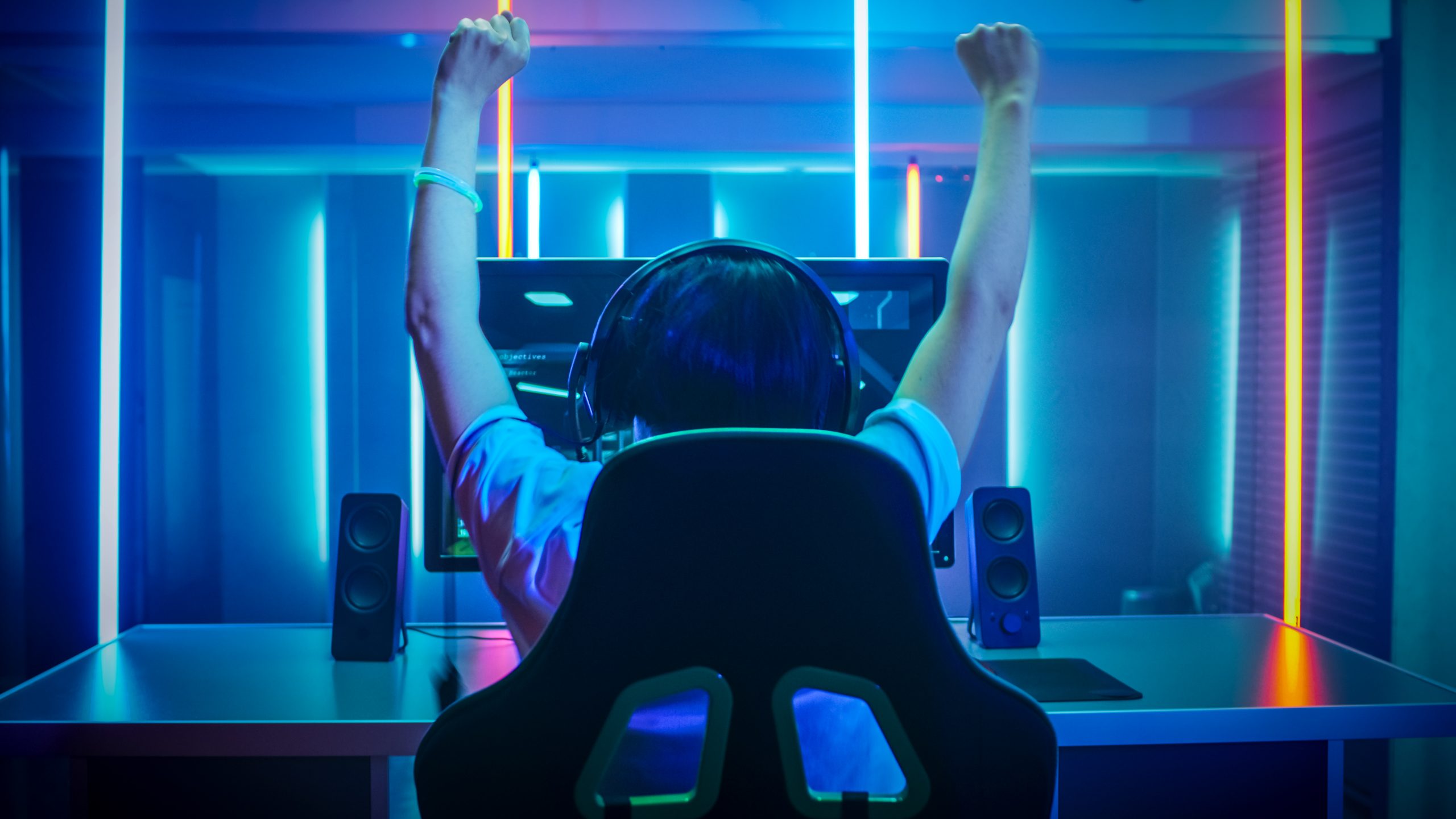 An e-sports athlete celebrating in front of his monitor
