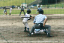 An umpire, pitcher, batter and a catcher preparing for a pitch
