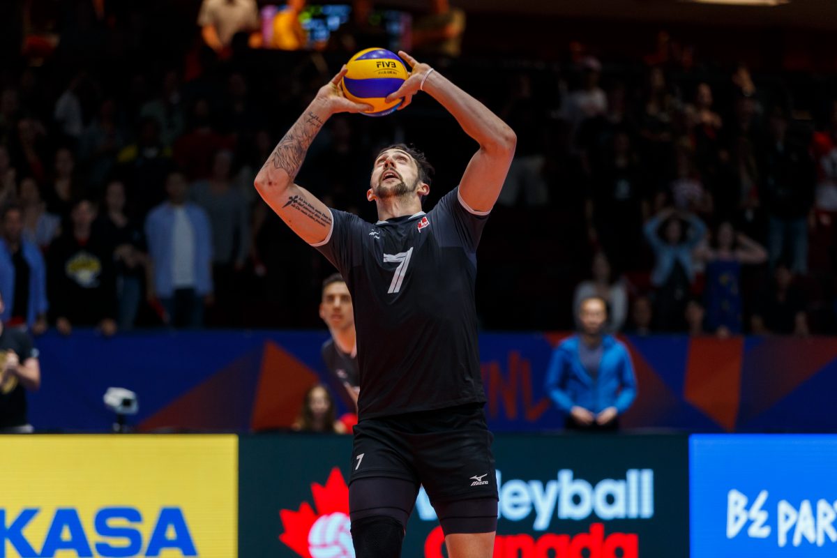 Male volleyball athlete preparing for a serve