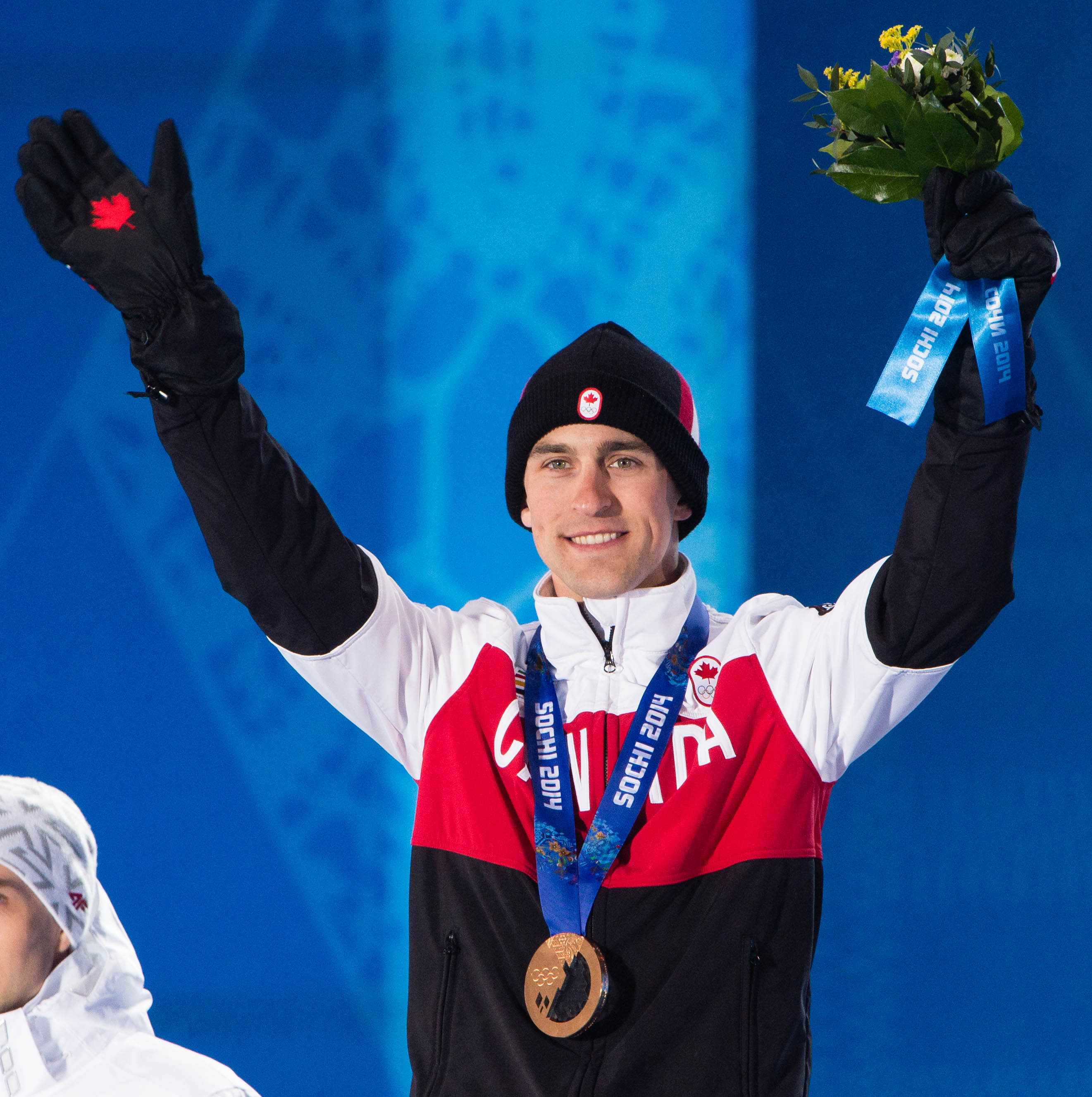 Denny Morrison receives the bronze medal in men's 1,500m long track speed skating at the 2014 Sochi Winter Olympics in Sochi, Russia, Sunday, Feb. 16, 2014. .THE CANADIAN PRESS/HO, COC - Winston Chow