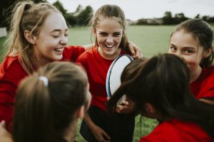 Cheerful young rugby players on the field