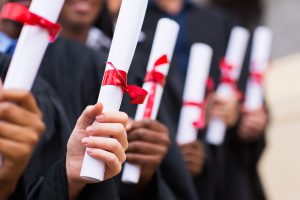 group of graduates holding diploma