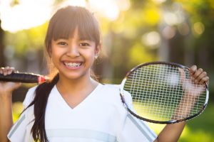 young girl holding a badminton racket, Outdoor