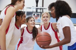 Female coach and youth basketball team