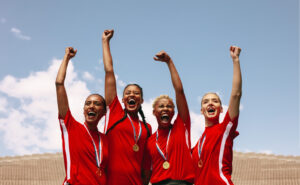 Professional female soccer players celebrating a victory