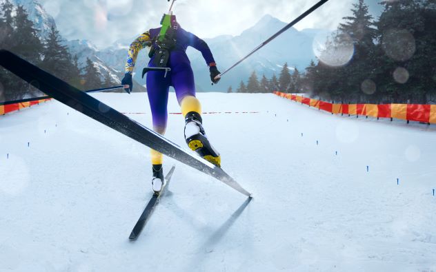 Female biathlete skiing toward finish line