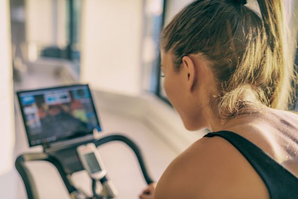 Female athlete training on peloton.