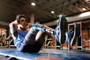 Young male athlete with a disability training in a gym, unhappy