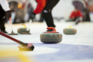 Curling athletes competing.