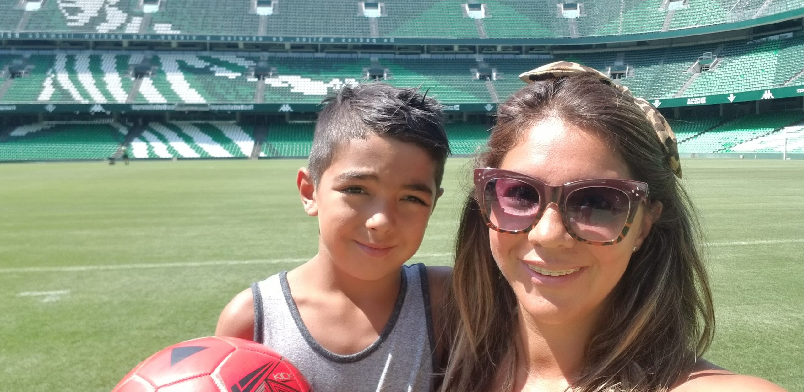 Mom Dalila with her son in a baseball stadium.