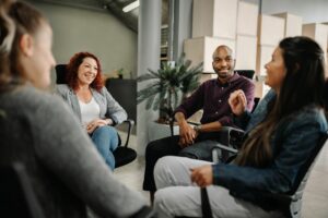 Diverse group of business people sitting in circle. Coworkers in a team building session.