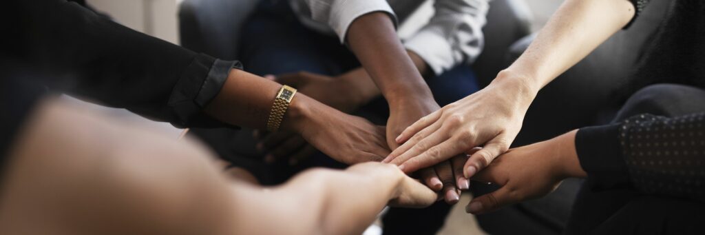 Diverse workplace doing a hand stack at a meeting