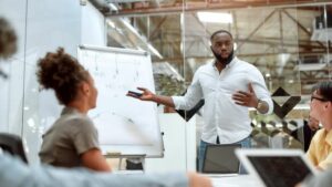 Man leads meeting in a boardroom