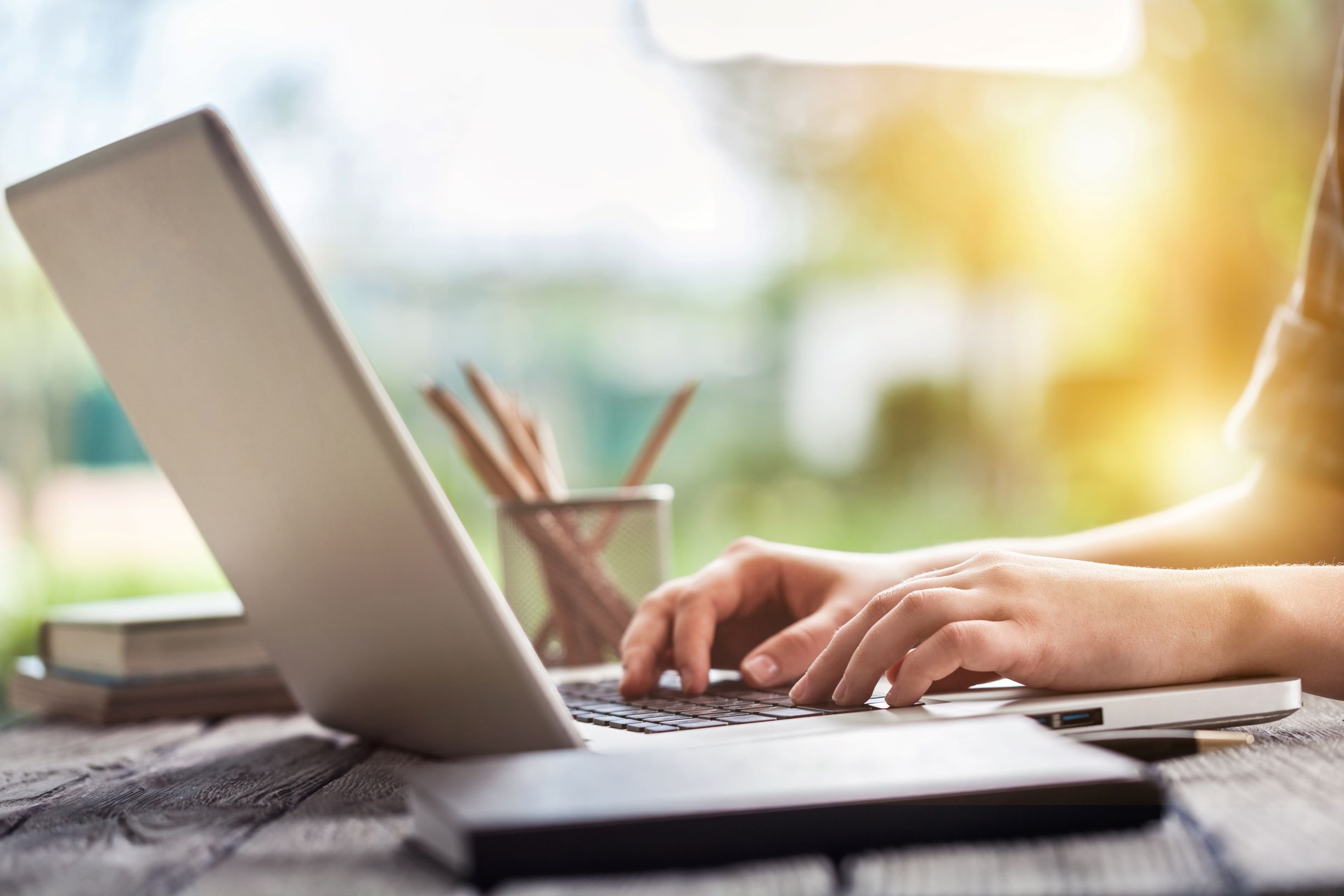 Close up image of person working on laptop