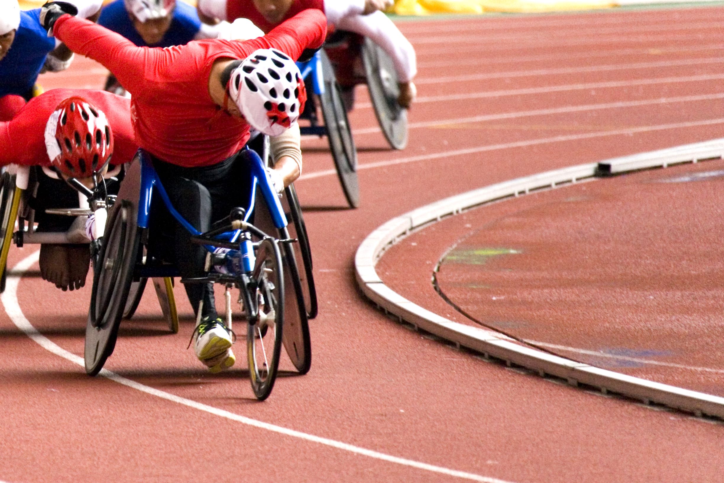 Para-athletics race. Closeup view of leading athlete during a race on the track.