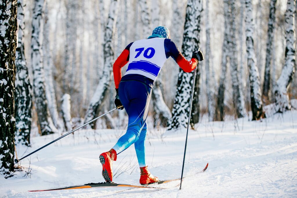 Nordic ski racer moving in classic style during competition.