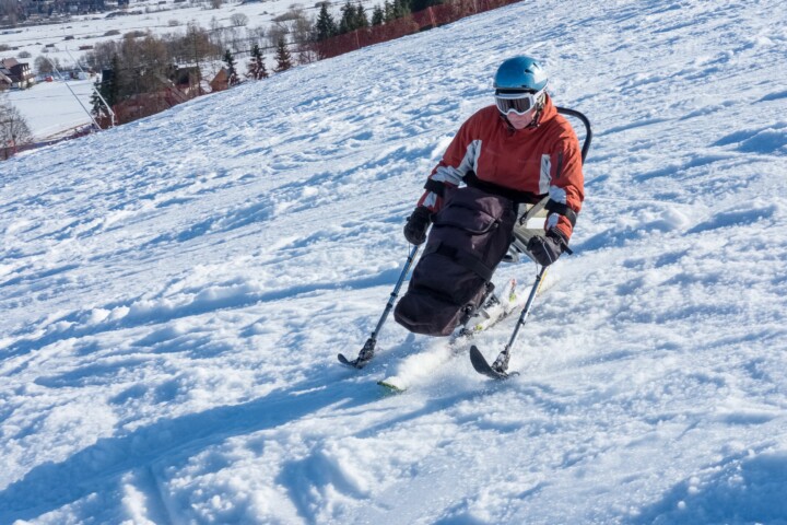 Para-alpine skier going down the hill.