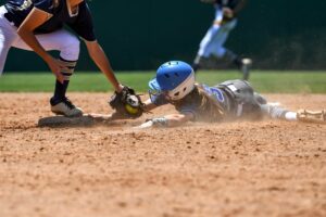 Young high school softball players in action, making amazing plays, during a game.