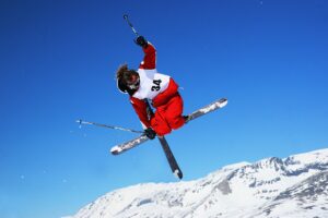 Action shot of a freestyle ski athlete doing a trick in the air.
