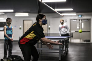 A youth hockey goalie throwing a ball against a wall to improve hand eye coordination