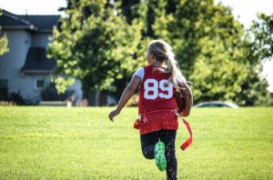 Girl playing flag football 