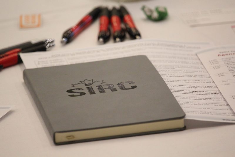 SIRC notebook and pens on table