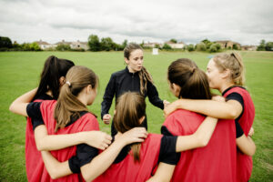 Rugby players and their coach gathering before a match