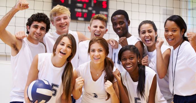 Female and Male teenage volleyball players take a picture