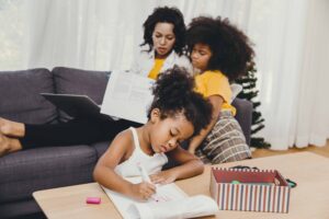 Mother with her kids, sitting on a couch