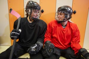 Two women hockey players in their locker room