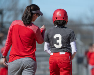 Coach and athlete during a Softball game
