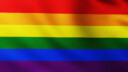Large Rainbow Flag of LGBT Community background in the wind with wave patterns