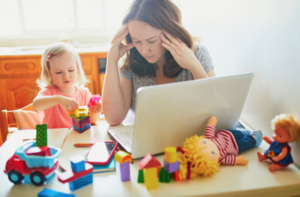 Stressed mom sitting at table with her daughter 