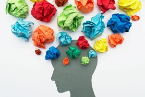 A picture of a head with wrinkled up coloured paper