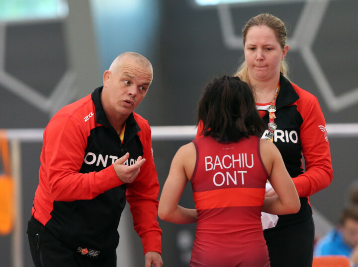Coaches speaking to their athlete during the 2017 Canada Games