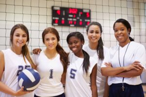Black female volleyball coach with her athletes