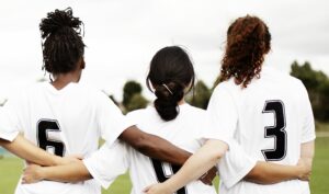 girl soccer players on a sideline