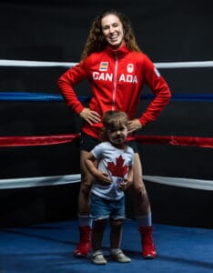 Mandy Bujold with her daughter in a boxing ring posing for a picture