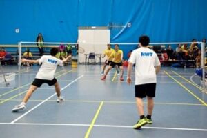 NWT athletes playing doubles in badminton