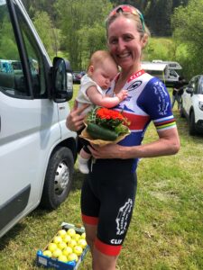 Catharine Pendrel holding her baby her daughter after a competition 
